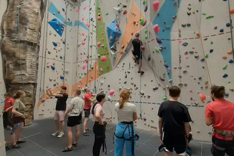 Participants visit a climbing wall. 